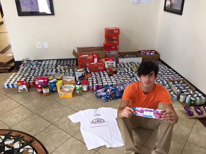 Faris Abuzahra sorting canned food for Nourish Food Bank, 2015
