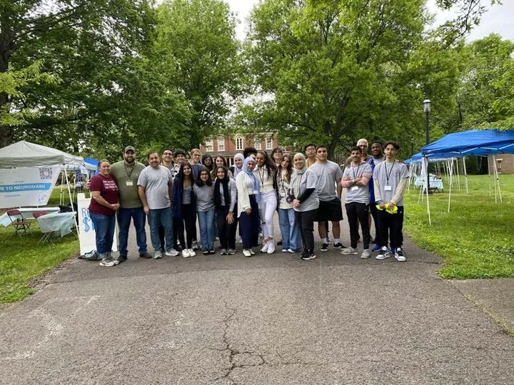 MMY youth and volunteers outdoors at a community event, 2023