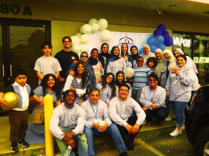 MMY youth, families, and volunteers at a celebration, 2025