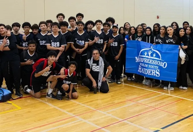 The Murfreesboro Muslim Youth Raiders MIST team with their banner