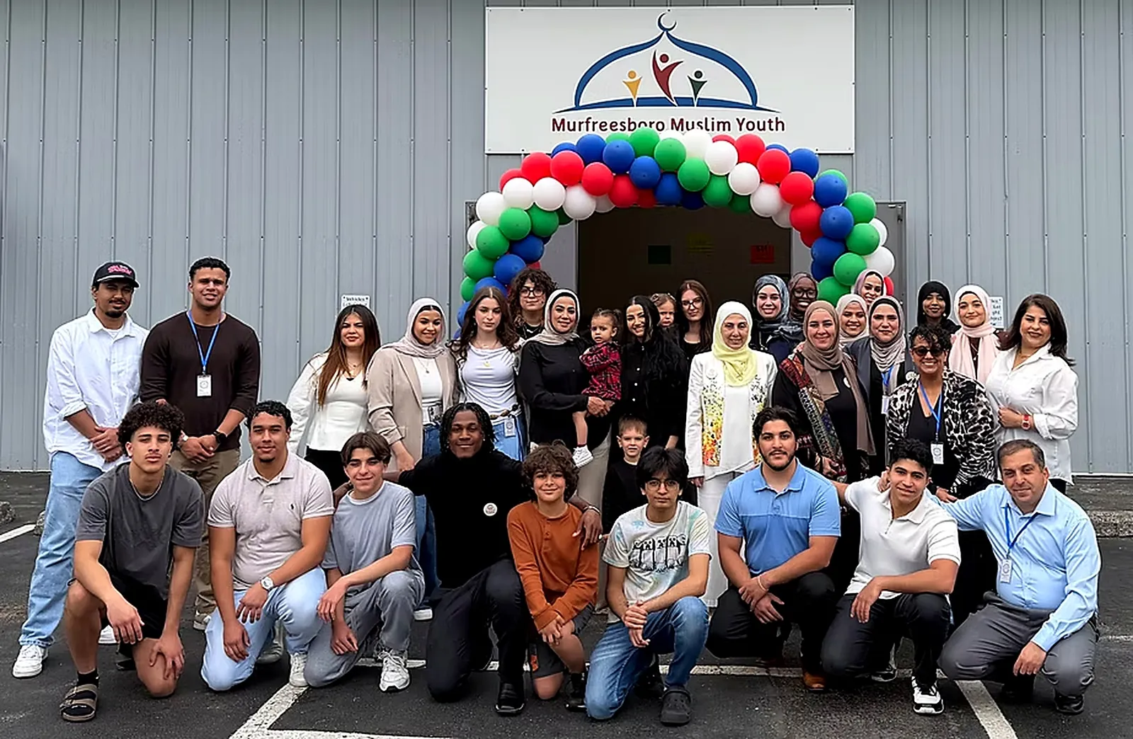 MMY youth, families, and volunteers gathered under a balloon arch at the grand opening of the MMY Center in Murfreesboro