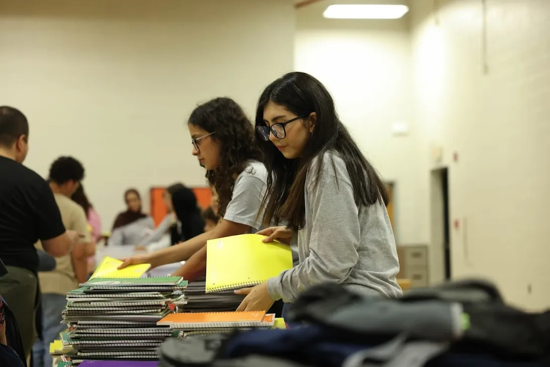 MMY volunteers sorting school supplies for the School Supply Giveaway