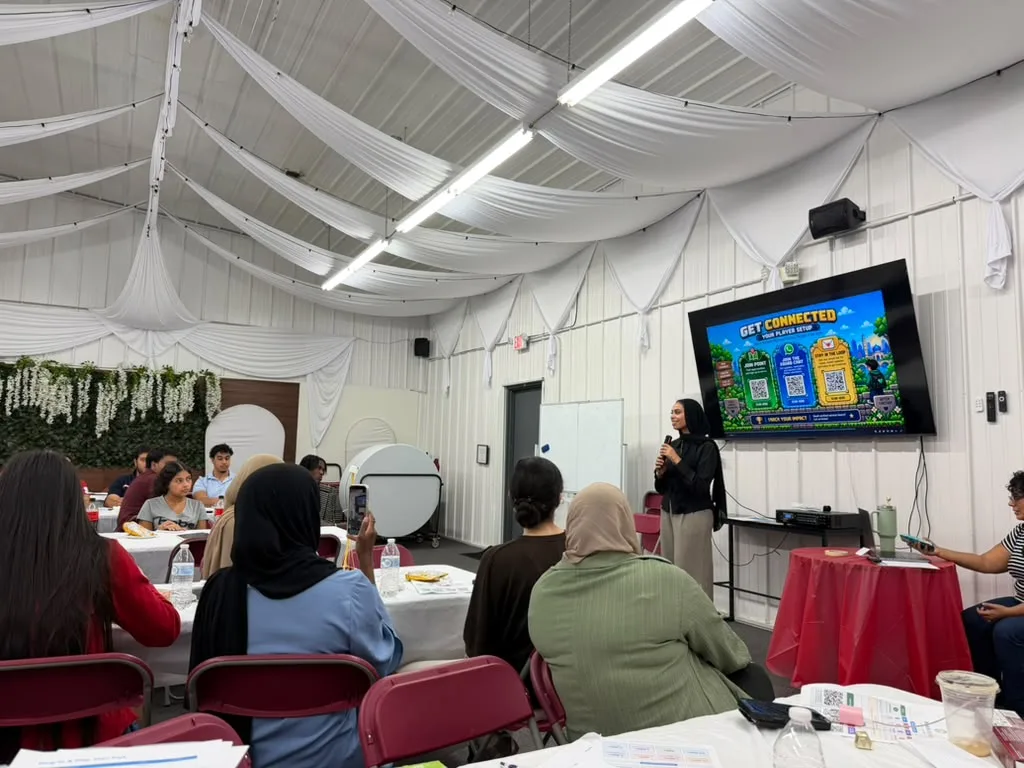 MMY volunteers learning about MMY's history at a volunteer onboarding event