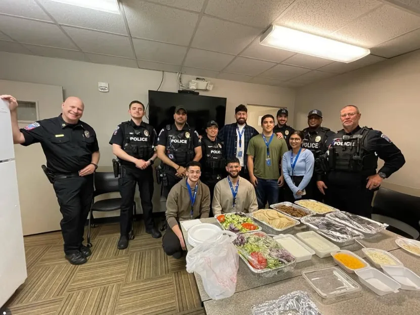 MMY at MTSU members serving a meal to MTSU Police officers at a campus appreciation event