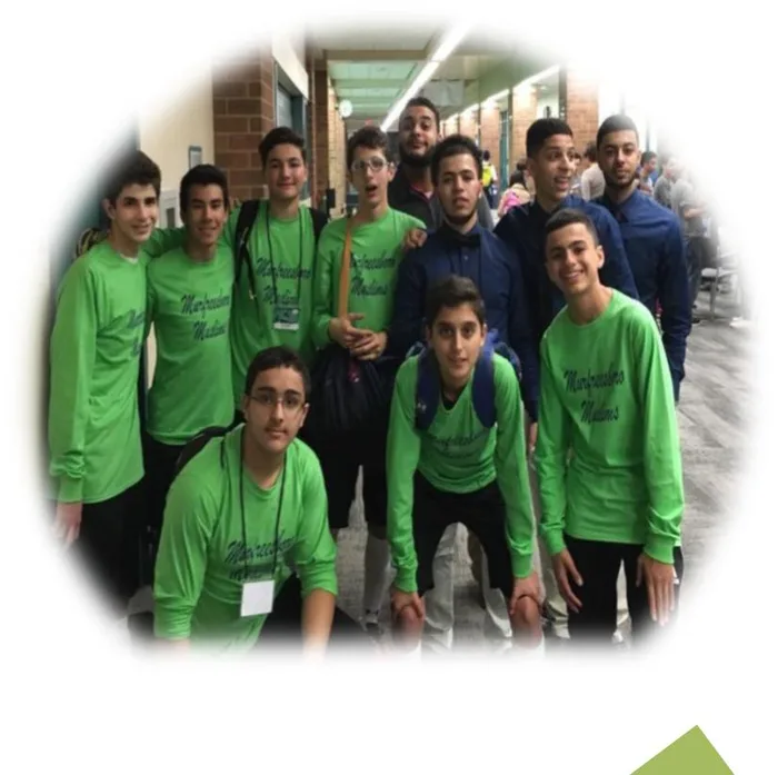 A group of green-shirted MMY volunteers