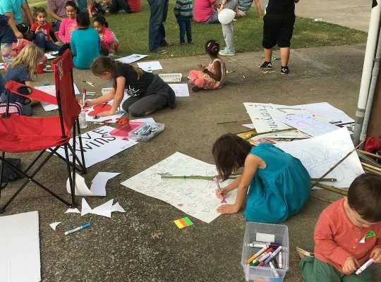 Children doing an art activity outdoors at an MMY event