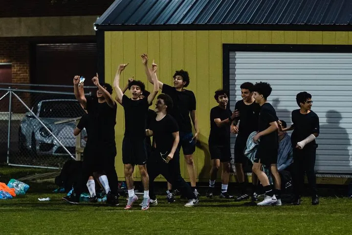 MMY Boys' Club soccer players celebrating on the field